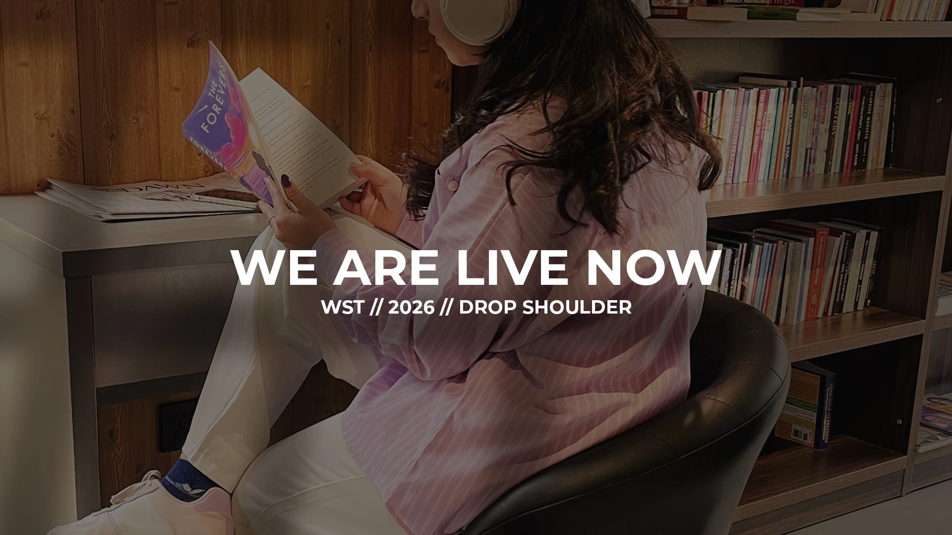 Woman wearing modest oversized drop shoulder shirt while reading, VOGSIX 2026 drop shoulder collection